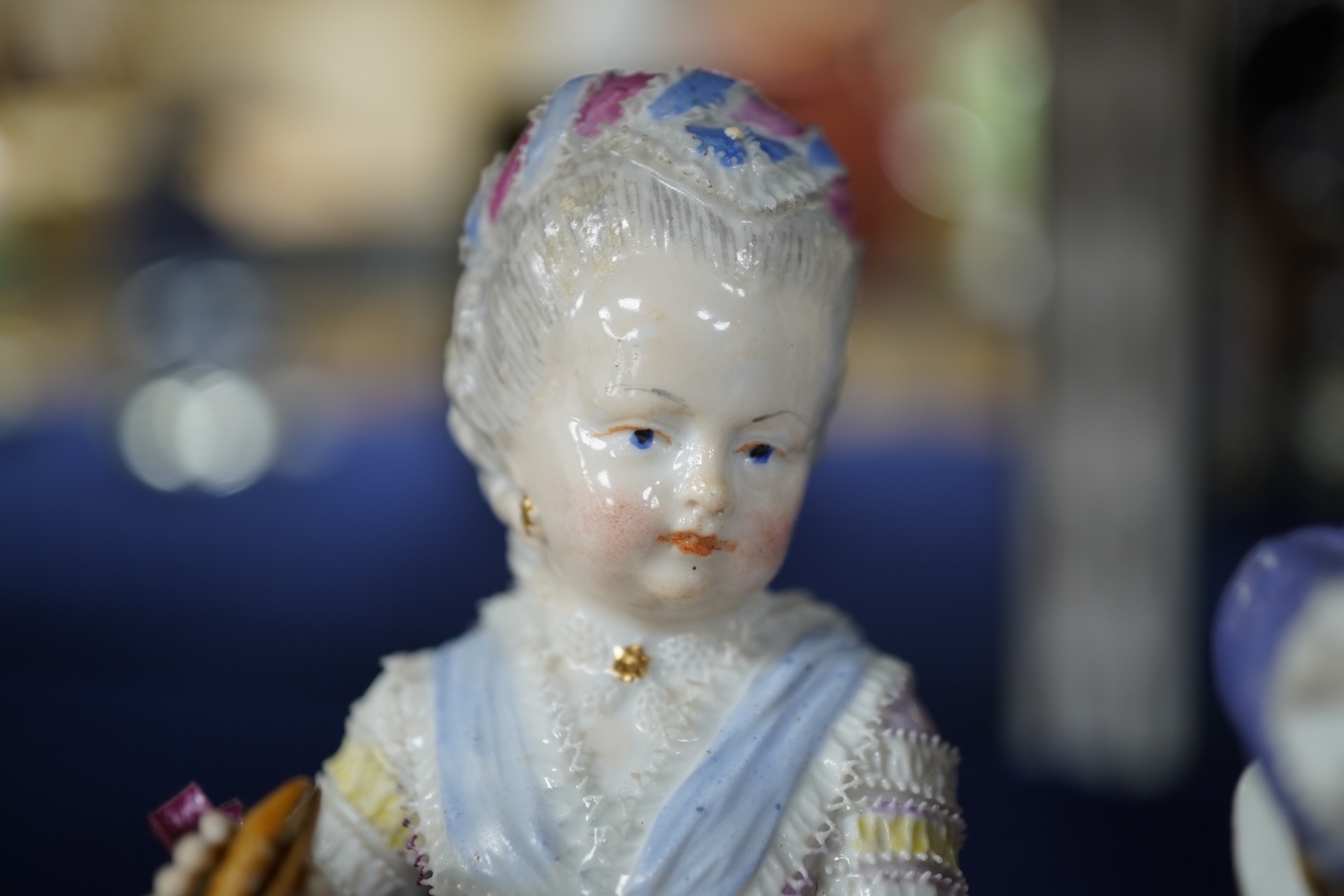 A pair of 19th century Meissen figures of a girl holding a shell and a boy holding a book, in size model number 628, tallest 13cm